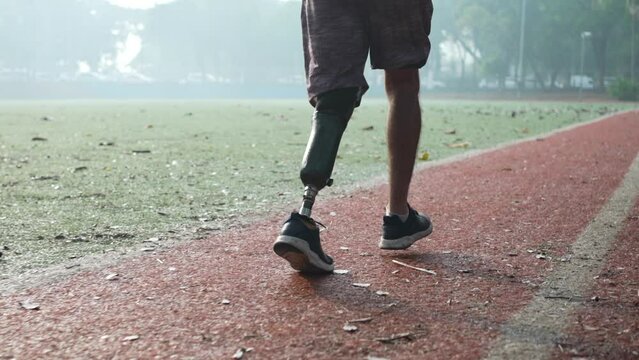 Amputee athlete running with prosthetic leg. Disabled runner with prosthesis. Determination and motivational concept