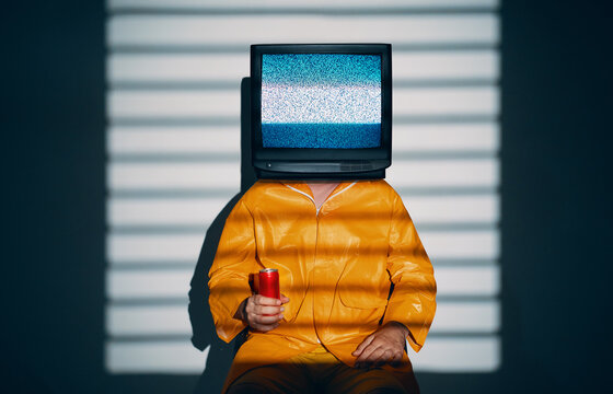 Surreal art of TV addicted man with television instead of head.