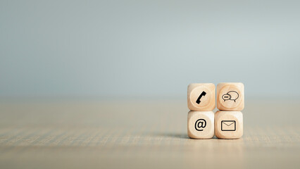 Contact us service support or e-mail marketing concept. Hotline people connect for Website page banner and wooden coins with symbol telephone, email, address. copy space for text.