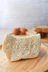 Close up of cheese, milk , brown bread and almond nut on table.