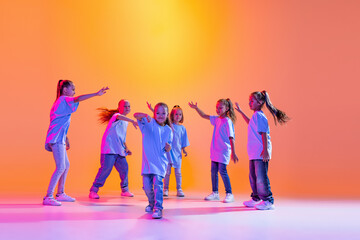 Hip-hop dance, street style. Happy children, little active girls in casual style clothes dancing...