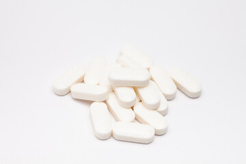 Fototapeta na wymiar Pills drugs tablets vitamins macro image on white background