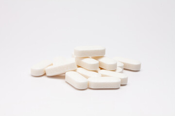 Pills drugs tablets vitamins macro image on white background