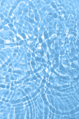 Fresh water background. Bright blue pattern with natural rippled water texture and bubbles. Top view with copy space. Clear water surface background.