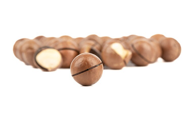 Selective focus on macadamia nut on white background.