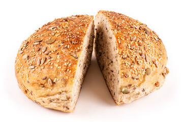 Round bread made of whole wheat flour with an appetizing crust with seeds cut in half on a white isolated background. Close-up. Bread without yeast, with sourdough. Template for the design.