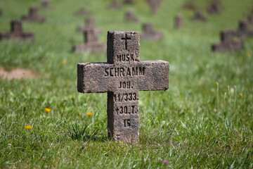 Old Christian cemetery with stone crosses among the grass - military abandoned cemetery