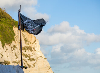 A dastardly skull and crossbones pirate flag waving in the wind. Calico Jack.