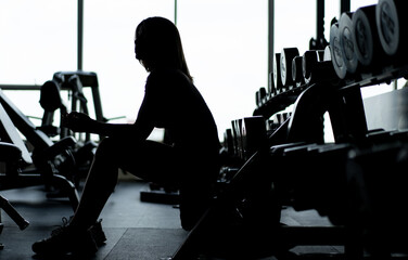Fototapeta na wymiar Silhouette woman exercising in the gym, woman asian