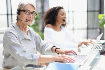 operator woman agent with headsets working in a call centre.