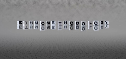 ethnomethodology word or concept represented by black and white letter cubes on a grey horizon...