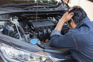 Man are checking the car. Car having trouble ,broken car on the way travel.
