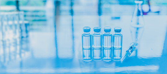 Concept of chemical, scientific experiment, monkeypox virus. Closeup, copy space on right. Chemistry experiments in science labs. Chemical vaccines on a table. Blurred background