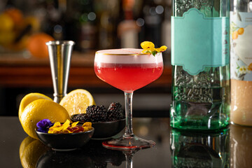Pink Gin and Lemon & Blackberry Cocktail with Pansy Garnish.