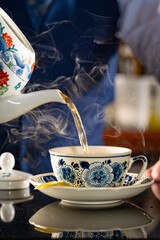Smoked Cocktail being poured from Teapot into Teacup