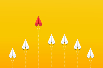 Leadership. Different thinking concept. The red paper plane leaves the group of white on yellow background. Business concept for new ideas creativity, innovative solution. 