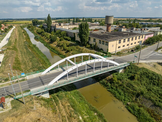 Fototapeta premium Hungary - Simontornya - Sio river is going under the bridge from areal view