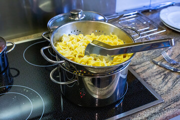 close-up of a stove with pot and pasta