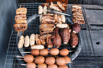 Thai street food: grilled bananas, sweet potato and boiled eggs. Chiang Khan, province of Loei, Thailand.

