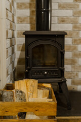 fragment of an interior with a stove and firewood in a small house. High quality photo