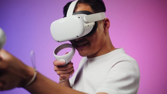 Korean man using virtual reality glasses, playing video games, Asian guy wearing new generation gaming headset for entertainment, amusement park, future technology concept.
