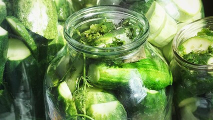 Canned cucumbers in glass jars, top view, preservation,