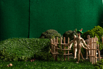 Articulated wooden dolls that simulate walking in a miniature world