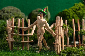 Articulated wooden dolls that simulate walking in a miniature world