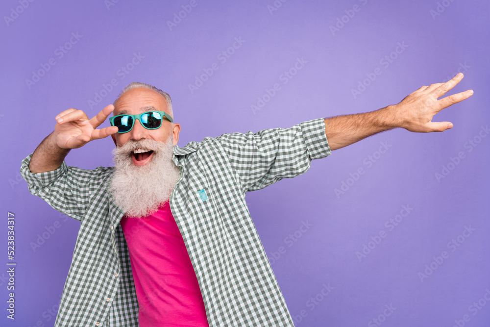 Sticker Portrait of excited carefree person enjoy dancing hand finger demonstrate v-sign isolated on purple color background