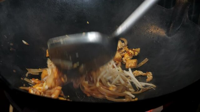 Slow motion video pad Thai in hot pan, popular street food in Thailand.