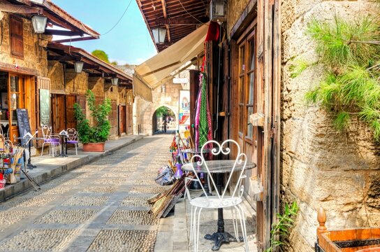 The old medieval pedestrian souk in Byblos, Lebanon during the day. A view of the little shops, old streets and alleys paved with little stones at the traditional outdoor market in Biblos to the town.