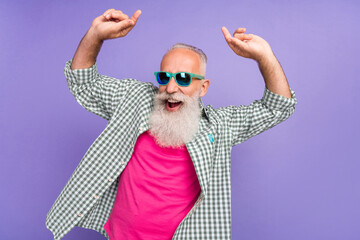 Portrait of positive excited person have fun dancing good mood feel young isolated on purple color background