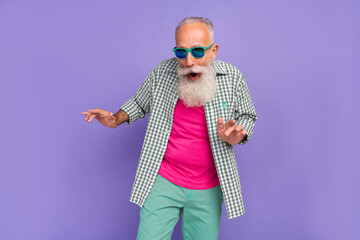 Photo of excited cheerful aged man have fun partying dancing spend pastime weekend isolated on violet color background