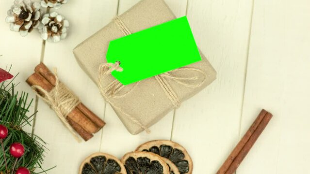 Box with twine and tag, background with copy space. Chroma key. Christmas card. View from above. Copy space - image. Camera zoom