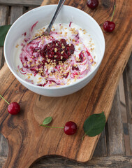Low carb breakfast bowl with greek yogurt, sour cherry compote and roasted hazelnuts