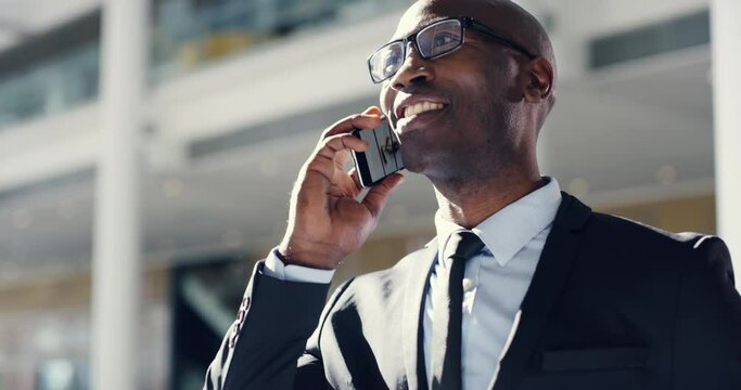 Business man talking on the phone, answering a call and communication while happy, smiling and laughing from below. Corporate professional male hearing good news, feeling motivated and ambitious