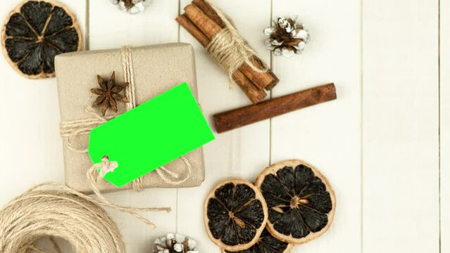 Box with twine and tag, background with copy space. Chroma key. Christmas card. View from above. Copy space - image. Camera zoom