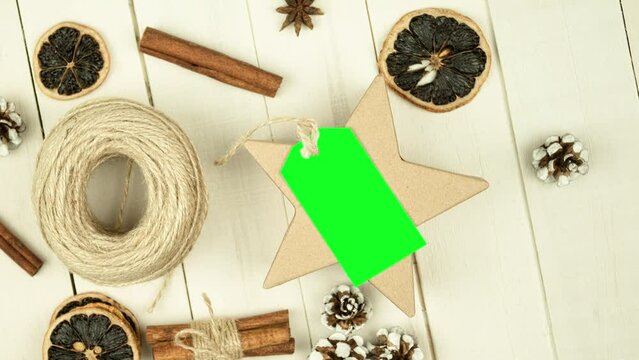 Box with twine and tag, background with copy space. Chroma key. Christmas card. View from above. Copy space - image. Camera zoom