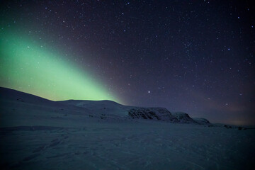 Fototapeta na wymiar Northern lights in Reinheim Cabin, Dovrefjell National Park, Norway