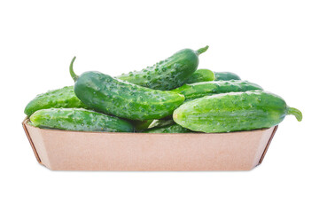 A cardboard basket is filled with fresh cucumbers