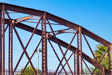 Metal structure of an old bridge with a useful design to support the weight of cars and trucks that cross the river	
