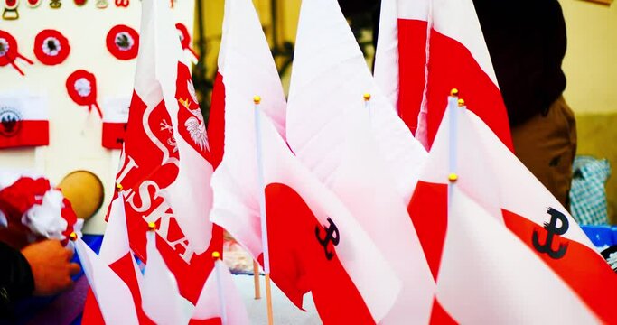 National Independence Day of Poland. Flag of Poland. The seller puts up for sale Polish flags with the coat of arms, wreaths, key chains and other souvenirs. Celebration in the Warsaw