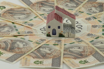 Money - Polish banknotes - and a miniature house