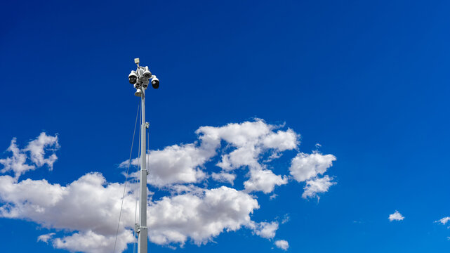 Low angle view of a CCTV mobile camera with clouds and blue sky