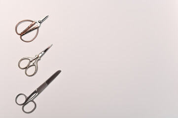 Three scissors with different handles. Sewing concept. Isolated. Top view, Flat lay.