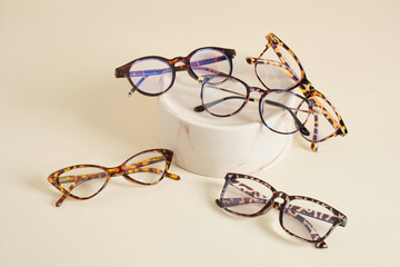 fashion eyeglass frames, glasses on ceramic podium, creative presentation of eyeglasses
