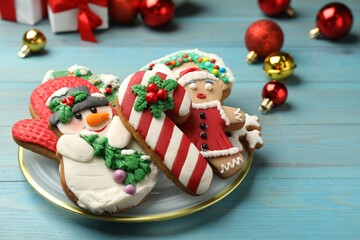 Sweet Christmas cookies and decor on light blue wooden table
