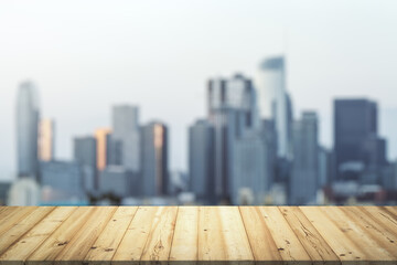Wooden tabletop with beautiful blurry skyscrapers on background, mock up