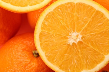 Cut and whole fresh ripe oranges as background, top view