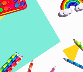 Art supplies with a rainbow - overhead view - flat lay
